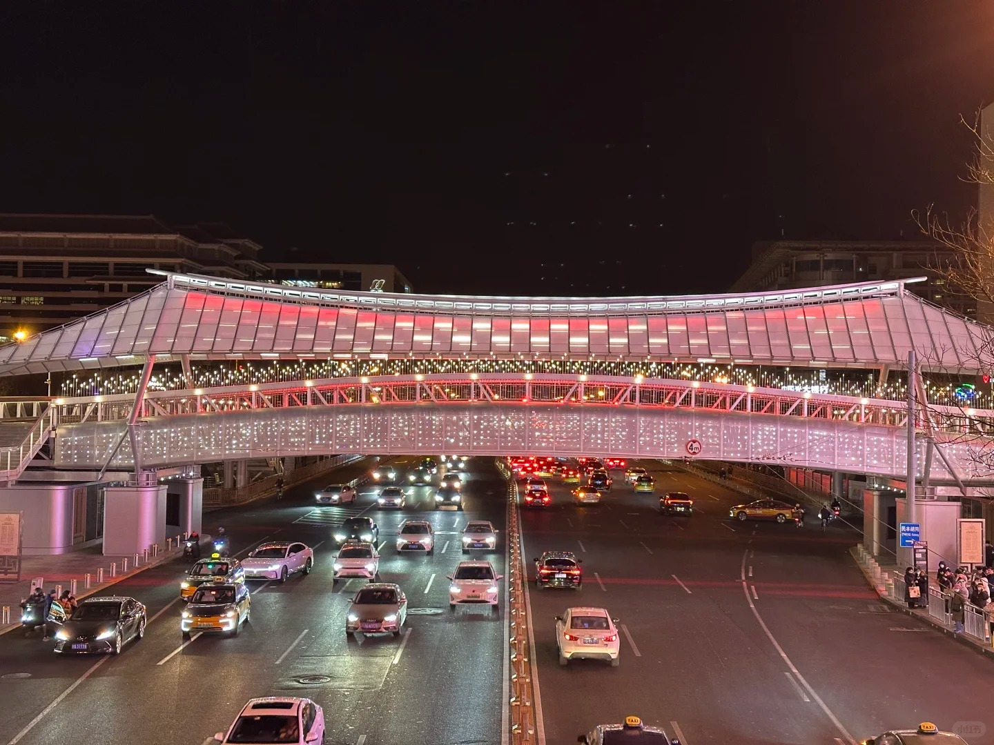 Cảnh đêm phố Xidan với ánh đèn neon phản chiếu trên mặt đường ướt mưa.